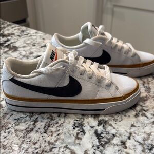 Nike White Sneakers with Black Swoosh and Gold Trim